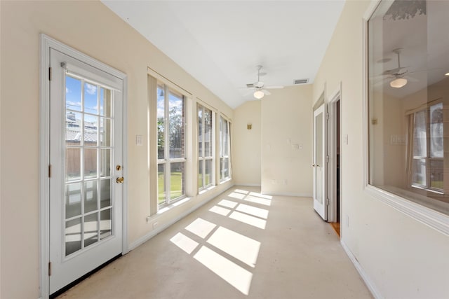 unfurnished sunroom featuring plenty of natural light, concrete flooring, and baseboards