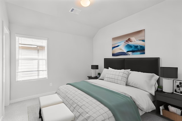 bedroom featuring light carpet and vaulted ceiling