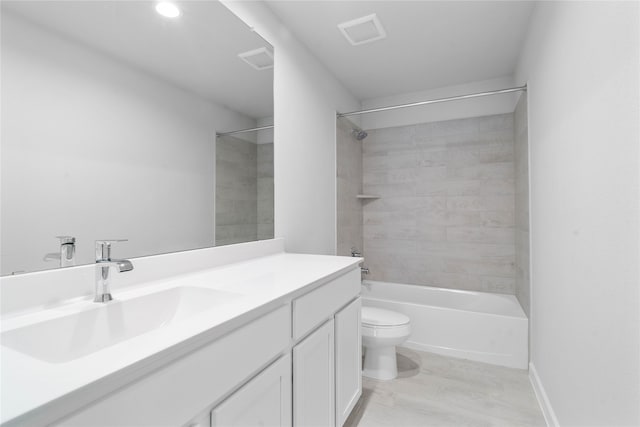 full bathroom featuring vanity, wood-type flooring, tiled shower / bath, and toilet