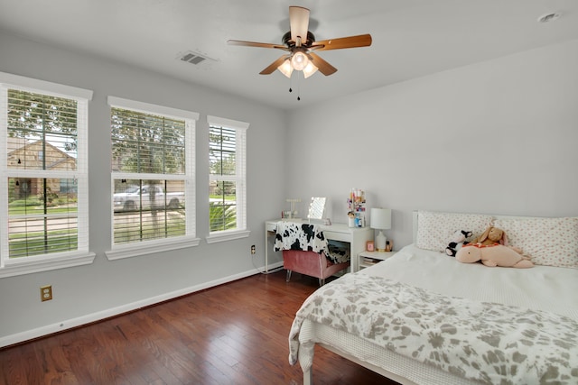 bedroom with dark hardwood / wood-style floors and ceiling fan