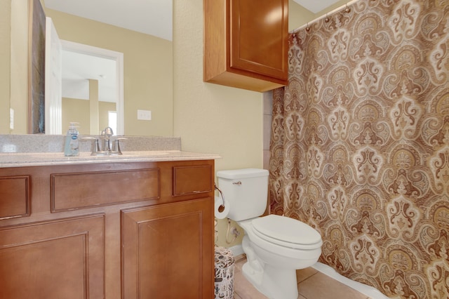 bathroom featuring toilet, walk in shower, vanity, and tile patterned flooring