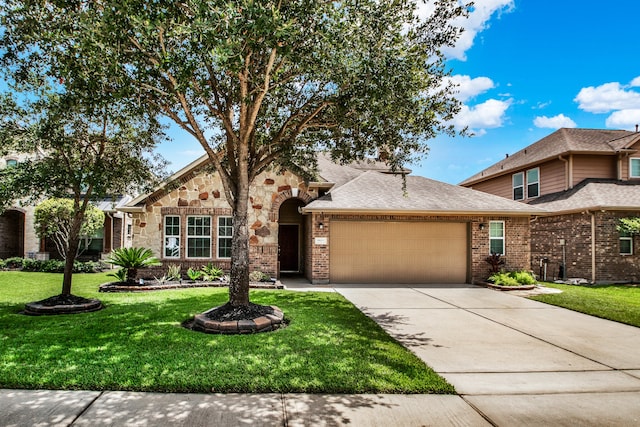 view of front of property with a front lawn and a garage