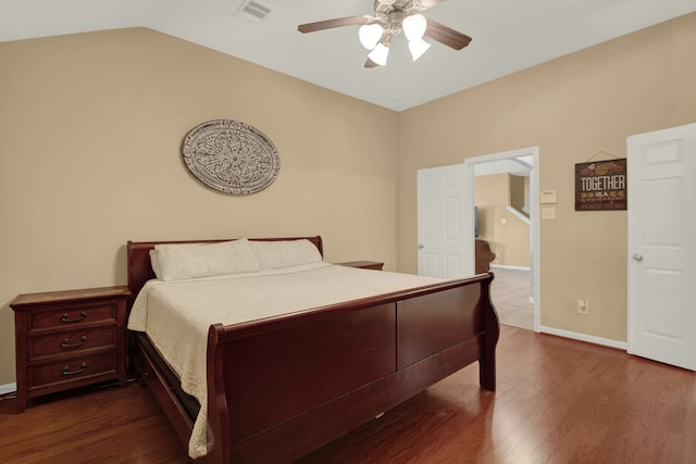 bedroom with lofted ceiling, dark hardwood / wood-style floors, and ceiling fan