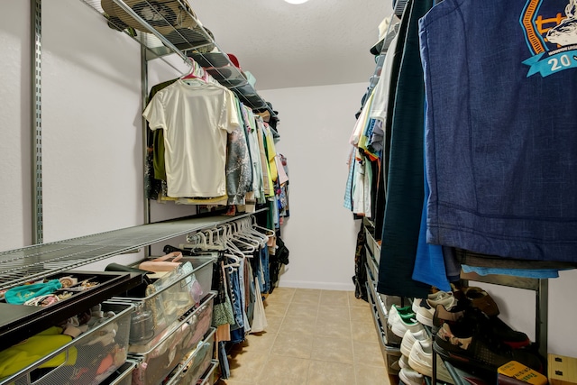 spacious closet featuring light tile patterned flooring