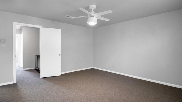 empty room featuring dark colored carpet and ceiling fan