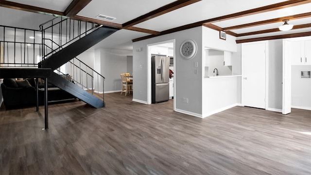 unfurnished living room featuring beam ceiling, sink, and dark hardwood / wood-style flooring