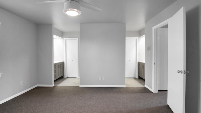 spare room featuring light carpet and ceiling fan