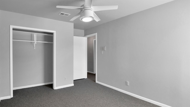 unfurnished bedroom featuring dark carpet, a closet, and ceiling fan