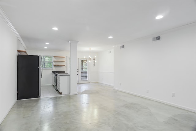 unfurnished living room with a notable chandelier and crown molding