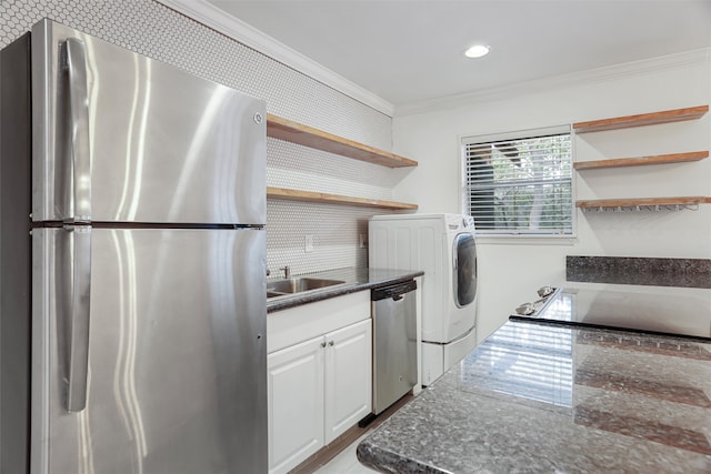 washroom featuring ornamental molding, sink, and washer / dryer