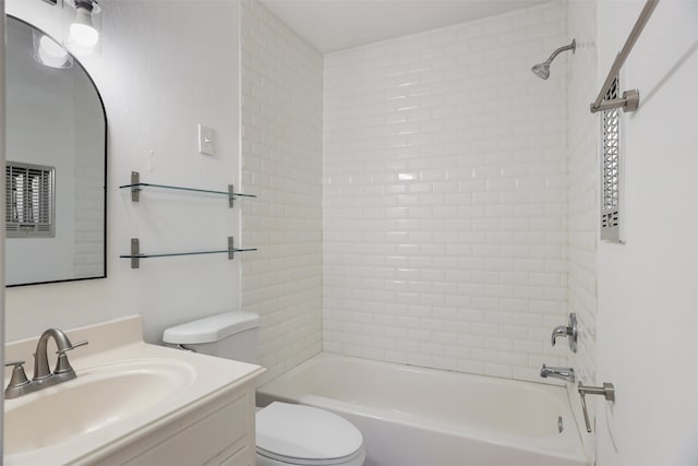 full bathroom with vanity, tiled shower / bath, and toilet