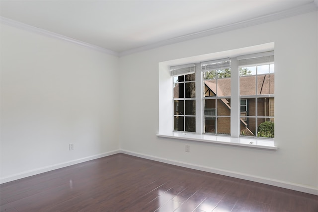 unfurnished room with a wealth of natural light, crown molding, and dark hardwood / wood-style flooring