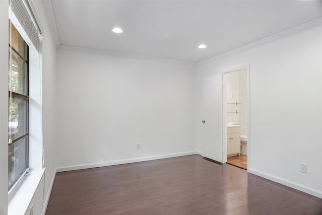 unfurnished room featuring dark wood-type flooring and crown molding