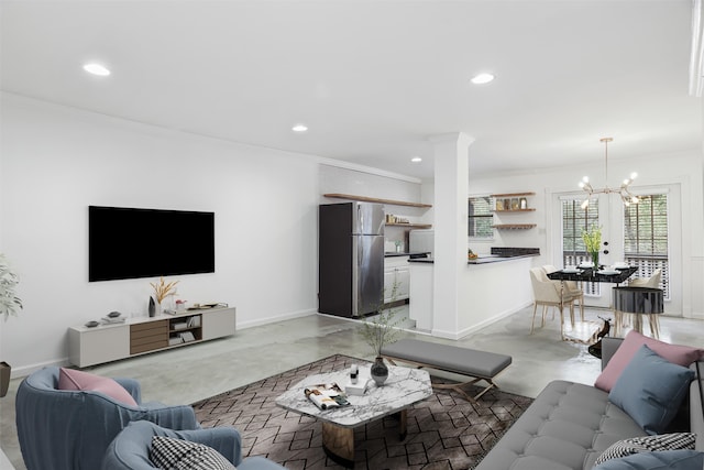 living room with crown molding, concrete floors, and a chandelier