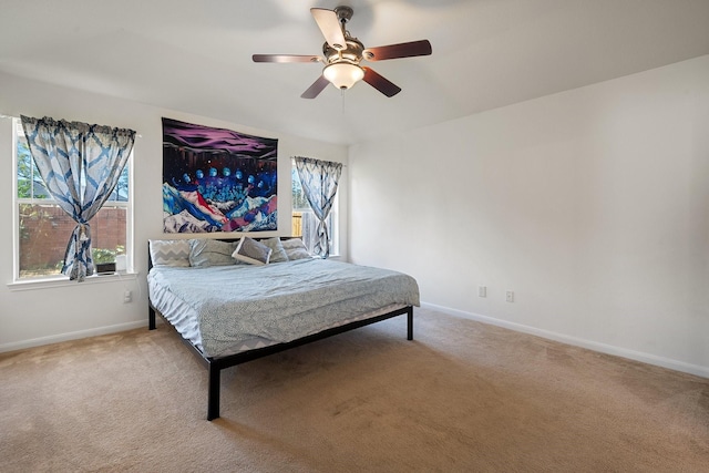 bedroom with ceiling fan and light carpet