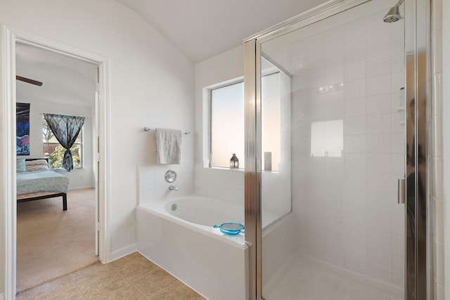 bathroom with tile patterned floors, vaulted ceiling, and independent shower and bath