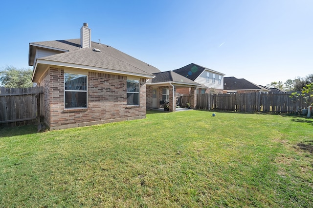 back of house featuring a lawn