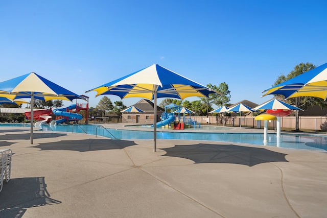 view of swimming pool with a patio area and a water slide