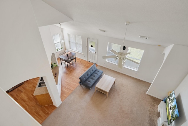 living room with light colored carpet and ceiling fan