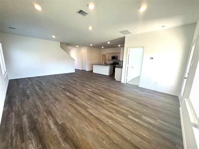 unfurnished living room featuring dark wood-type flooring