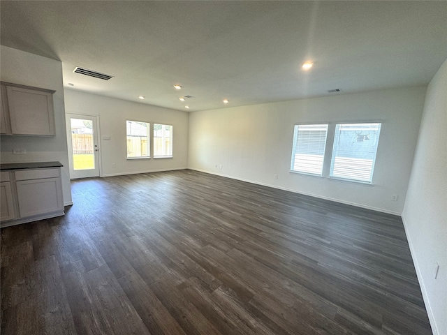 unfurnished living room featuring dark hardwood / wood-style flooring