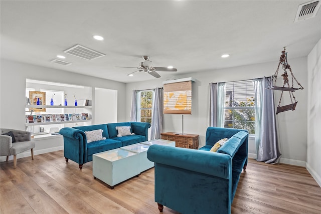 living room with wood-type flooring, a healthy amount of sunlight, and ceiling fan