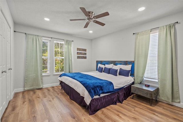 bedroom featuring a closet, light wood-type flooring, and ceiling fan