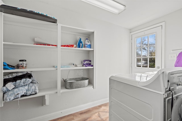 interior space with washer / dryer and light hardwood / wood-style flooring