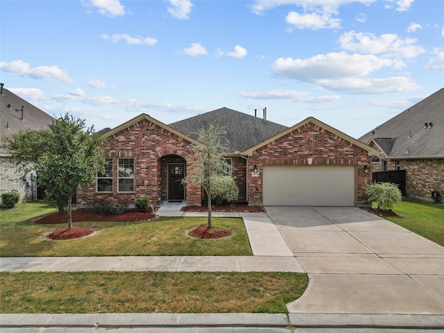 view of front facade with a front yard and a garage