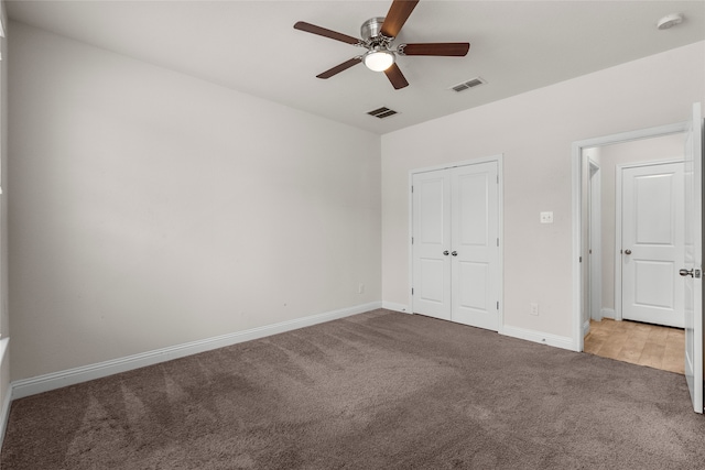 unfurnished bedroom featuring light colored carpet and ceiling fan