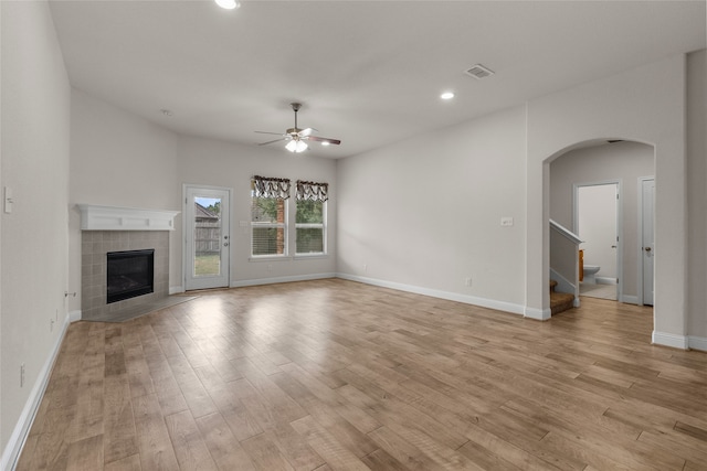 unfurnished living room featuring light hardwood / wood-style floors, a fireplace, and ceiling fan