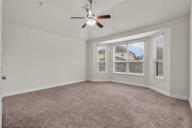 carpeted empty room with ceiling fan and vaulted ceiling