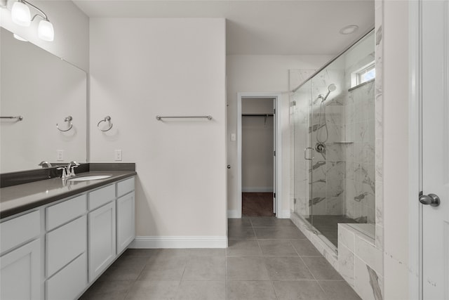 bathroom featuring vanity, tile patterned floors, and a shower with door