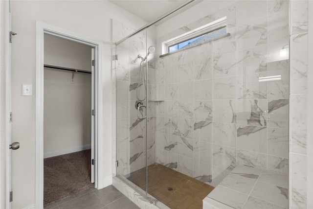 bathroom featuring an enclosed shower and tile patterned floors