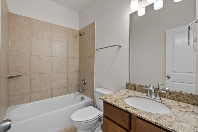 full bathroom with vanity, tiled shower / bath combo, and toilet