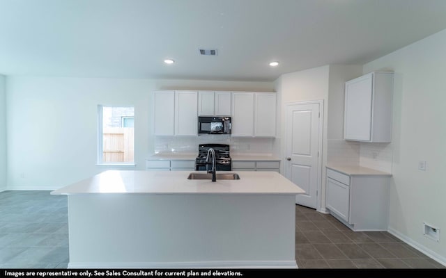 kitchen featuring white cabinetry, black appliances, and an island with sink