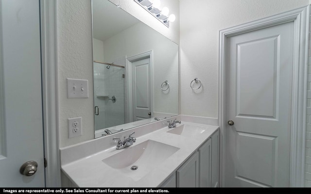 bathroom with vanity and a shower with shower door