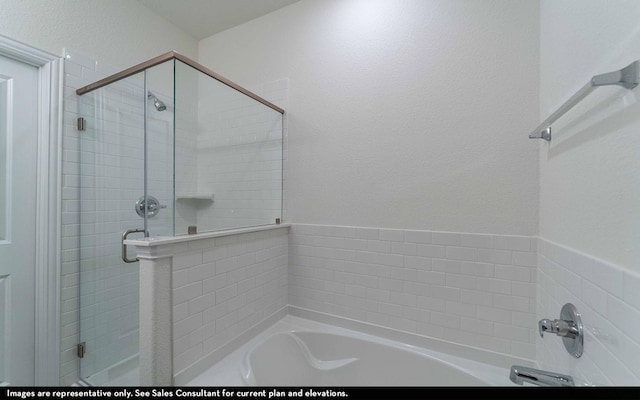 bathroom featuring shower with separate bathtub