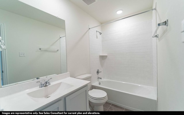 full bathroom featuring tiled shower / bath, tile patterned floors, toilet, and vanity