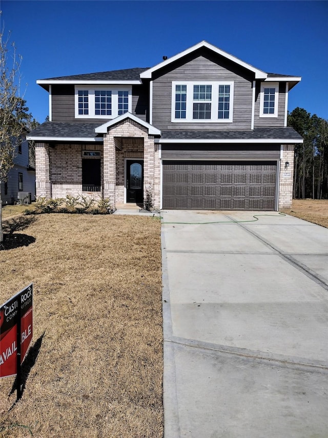 view of front facade featuring a garage and a front yard