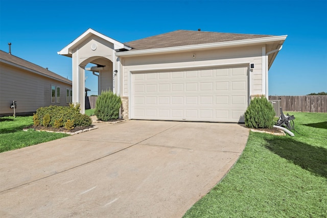 ranch-style house featuring a garage and a front lawn