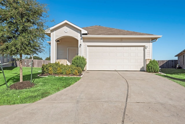 single story home featuring a garage and a front lawn