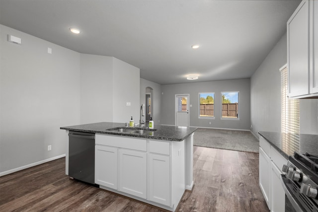 kitchen featuring white cabinetry, dark stone countertops, stainless steel appliances, and sink