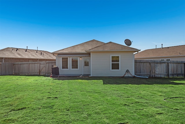 rear view of property featuring a yard