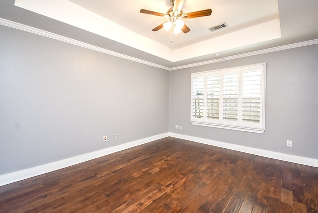 spare room featuring crown molding, a raised ceiling, wood-type flooring, and ceiling fan