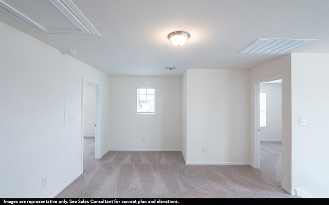 empty room featuring light colored carpet