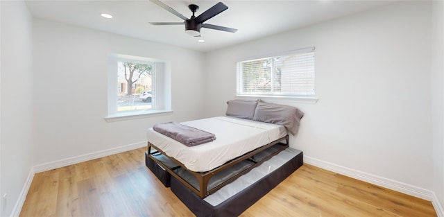 bedroom with hardwood / wood-style floors and ceiling fan