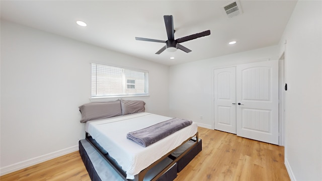 bedroom featuring a closet, light wood-type flooring, and ceiling fan