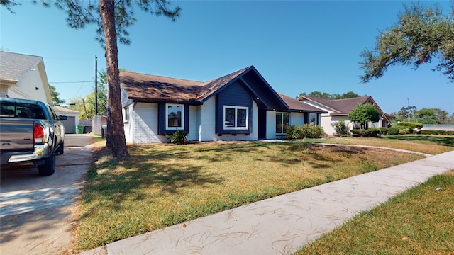 ranch-style home featuring a front yard