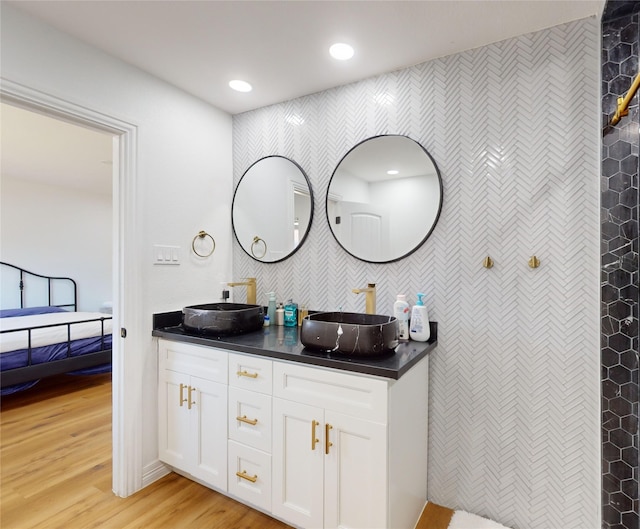 bathroom with vanity and hardwood / wood-style flooring